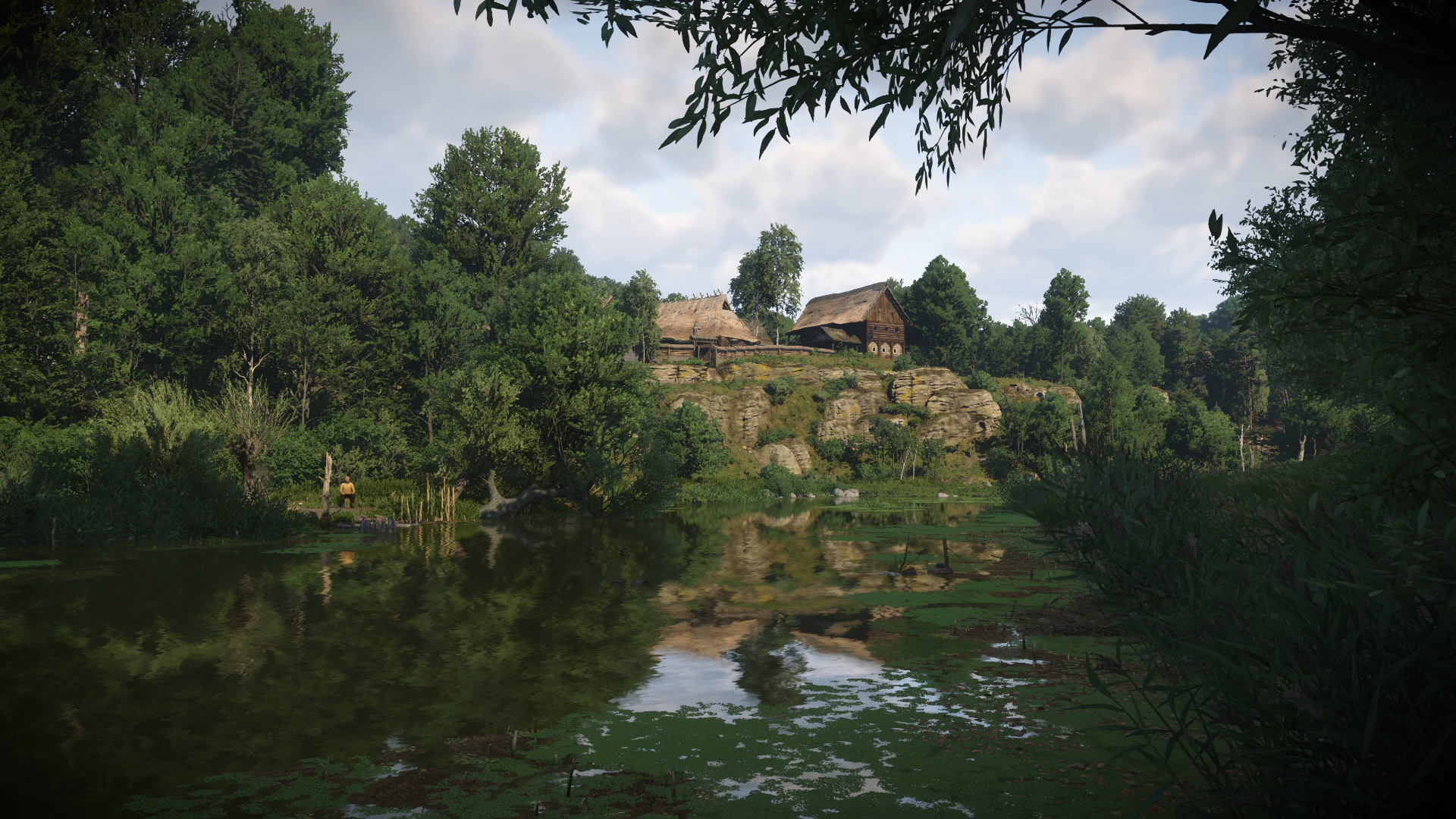 A village overlooking a lake in Kingdom Come: Deliverance 2