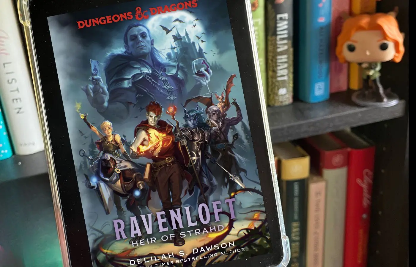Book cover for Ravenloft Heir of Strahd, in front of a bookshelf